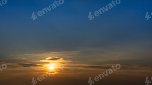 Preview: Dramatic sunrise sky with deep blue and warm tones creating a moody atmospheric background.