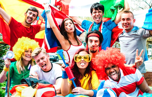 Preview: Young football supporter fans cheering with international flags at soccer match