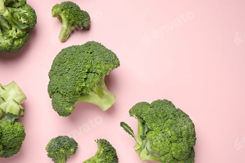 Preview: Fresh broccoli on pink background, flat lay. Space for text