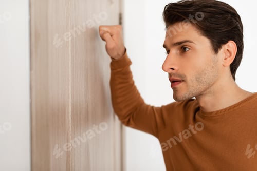 Preview: Closeup of guy knocking on the wooden door