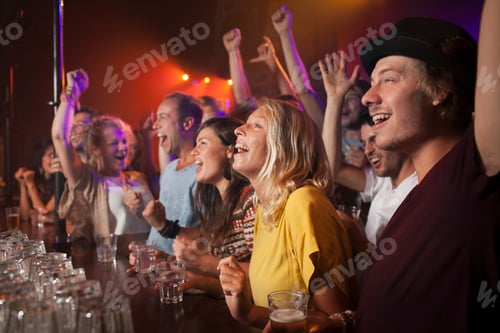 Preview: Group of friends enjoying live music at a bar