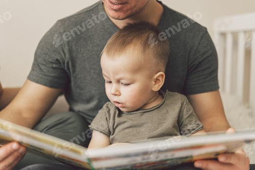 Preview: Family Love. Parents and Little Son Reading Book Together