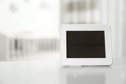 Preview: Digital temperature and humidity control in baby room interior. Space for text