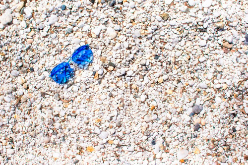 Preview: Closeup of sunglasses on tropical beach