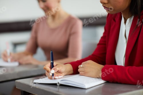 Preview: Businesswoman Writing in Planner