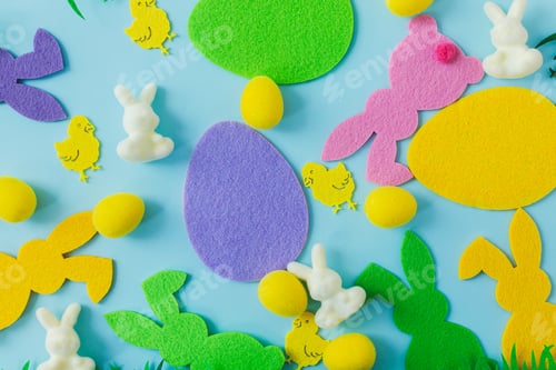 Preview: Colorful Easter bunnies, eggs, chicks composition on blue background flat lay. Happy Easter!