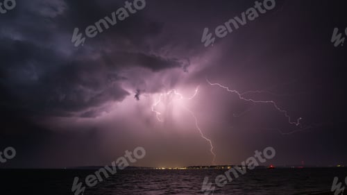 Preview: Low angle shot of a striking purple lightning sky over Isle of Wight, Hampshire