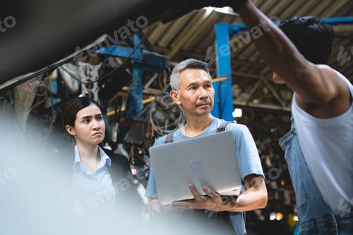 Preview: customer talking with professional mechanic worker or workshop owner, client checking a maintenance