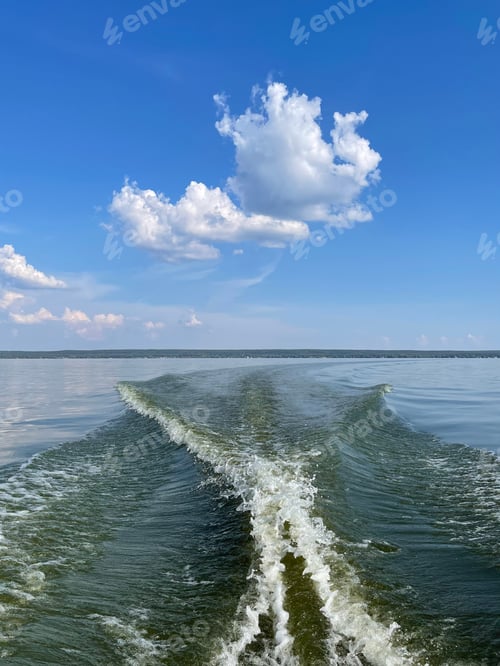 Preview: Waves emanating from a motor boat on a calm surface of the river