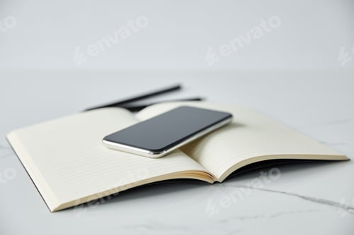 Preview: selective focus of smartphone with blank screen on notebook, pen and pencil isolated on grey