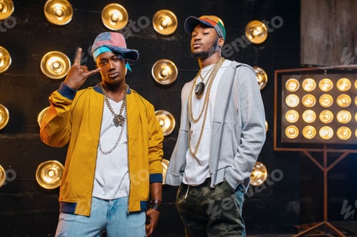 Preview: Black rappers in caps on stage with spotlights