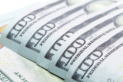 Preview: Detailed view of multiple hundred dollar bills arranged in a row on a neutral background