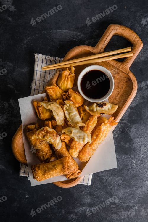 Preview: Asian appetizers a crispy egg roll, fried cream cheese wontons, and a pork dumpling (potsticker)