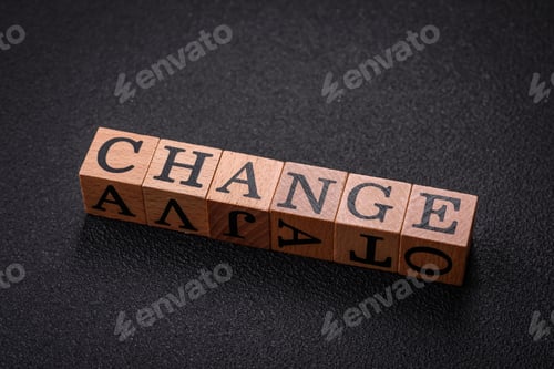 Preview: The inscription chance or change with wooden cubes on a dark concrete background