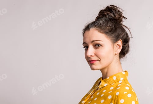 Preview: Portrait of a young beautiful woman in studio.