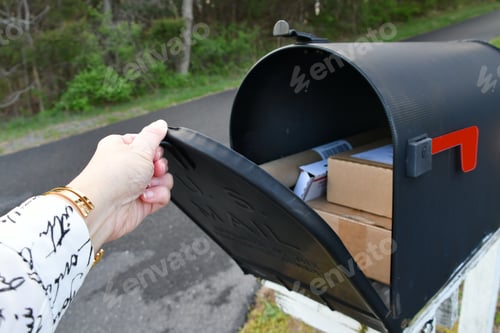 Preview: Opening a mailbox full of boxes packages delivered by the mailman USPS, generic brown box