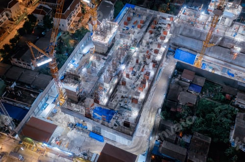 Preview: Aerial view of busy industrial construction site workers working. Development high rise building.