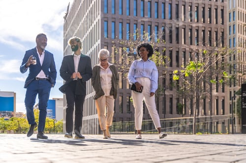Preview: Multiracial group of business people walking along a financial district