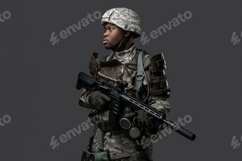 Preview: African army soldier with rifle posing against dark background