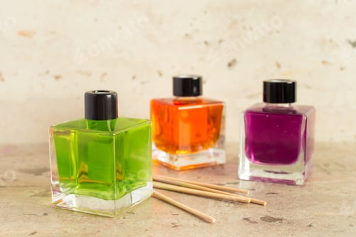 Preview: Colorful nail polish bottles arranged with wooden sticks on a light surface
