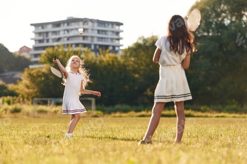 Preview: Game of badminton. Happy kids are on the summer field