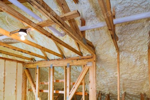 Preview: Foam plastic insulation installed in the sloping ceiling of a new frame house.