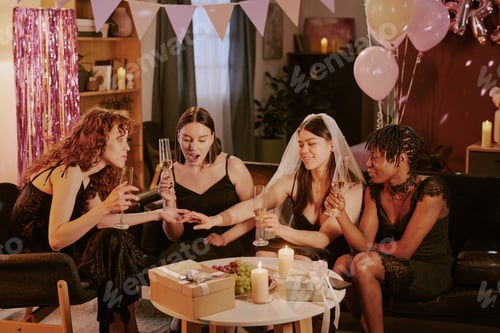 Preview: Multiethnic Young Adult Women Admiring Brides Ring and Toasting at Party