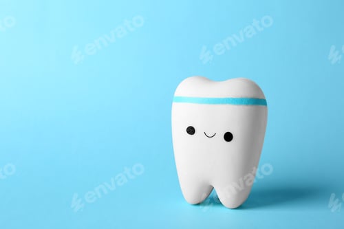 Preview: Model of tooth with happy face and space for text on color background