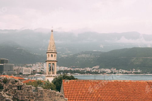 Preview: Old medieval town stone houses with red roofs and church bell towers. Budva is the center of tourism