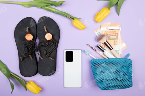 Preview: Travel flat lay with women sandals,smartphone,50 euro banknotes, yellow tulips and makeup brushes