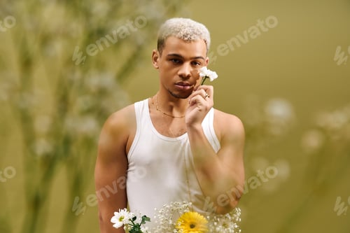 Preview: Young man showcasing vibrant style with flowers in a creative studio setting