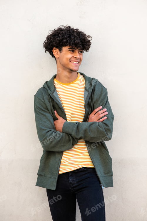 Preview: smiling cool young guy with arms crossed looking away