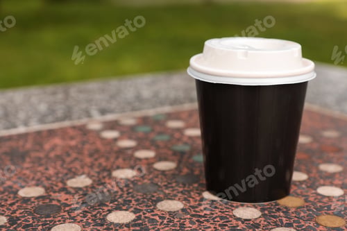 Preview: Paper cup on parapet table, space for text. Coffee to go