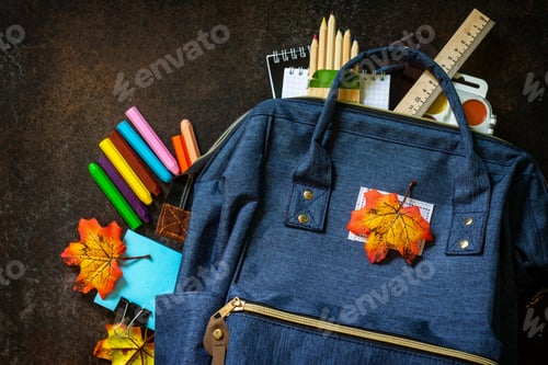 Preview: Back to school concept. School supplies with blue backpack on table. Top view flat lay.