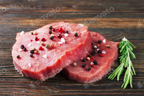 Preview: raw beef steak with rosemary on brown wooden background