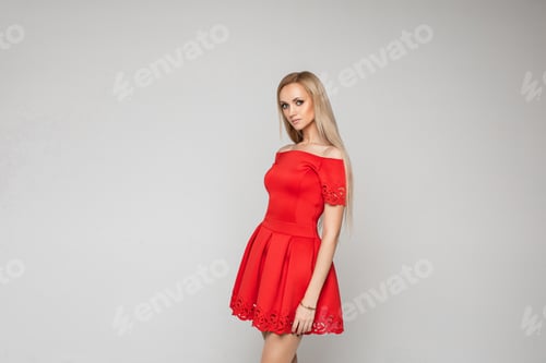 Preview: Serious attractive lady posing in beautiful red dress