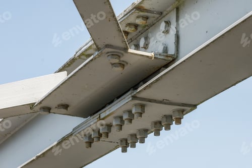 Preview: Bolts and nuts on metal plates of steel structure of heavy duty straight crossbar of frame
