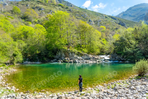 Preview: A young woman looking at the Olla de San Vicente lake, near Cangas de Onis. Asturias