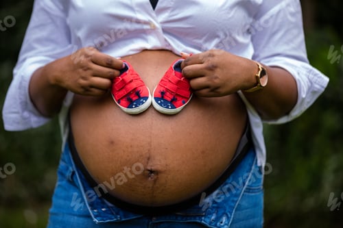 Preview: Baby bump pregnancy maternity hands details outdoors gardens Kenya