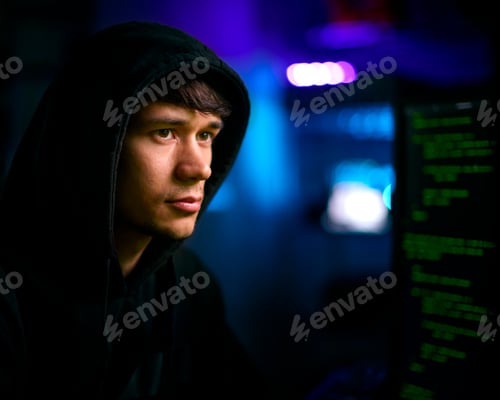 Preview: Low Key Lighting Shot Of Male Computer Hacker Sitting In Front Of Screens Breaching Cyber Security