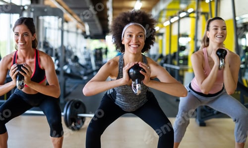 Preview: Beautiful women working out in gym together to stay healthy. Sport, people, friend concept.