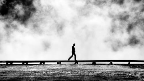 Preview: Silhouette of tourist on a footbridge.