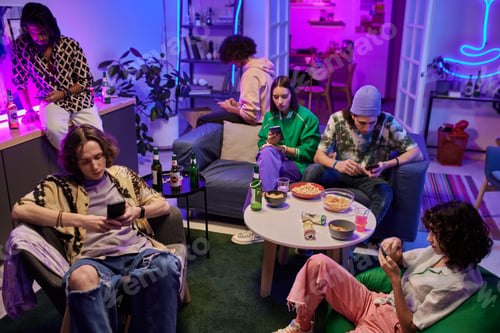 Preview: Group of young multicultural friends in casualwear using mobile gadgets