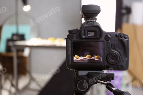Preview: Professional camera on tripod in studio, closeup. Food photography