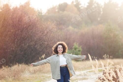 Preview: portrait of young pretty mixed race teen girl outdoor in autumn. happy woman with finely curly hair