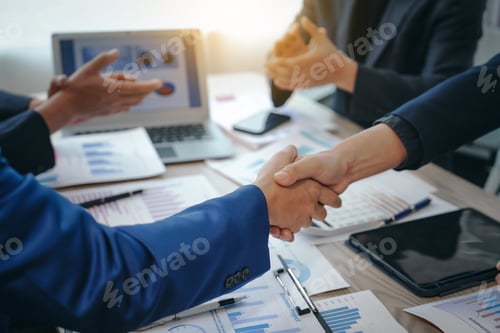 Preview: business team meeting, success is celebrated with handshake. Hands close up, dressed in formal suit