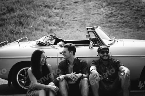 Preview: Group of Diverse Friends on Road Trip Sitting by the Car Togethe