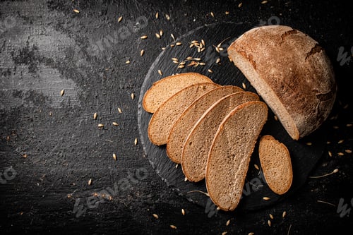 Preview: Slices of fresh bread on a stone board.