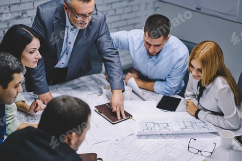 Preview: professional architects analyzing sketch cooperating in company