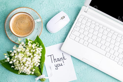 Preview: Notes thank you, coffee cup, laptop, bouquet of flowers lily of the valley on desk